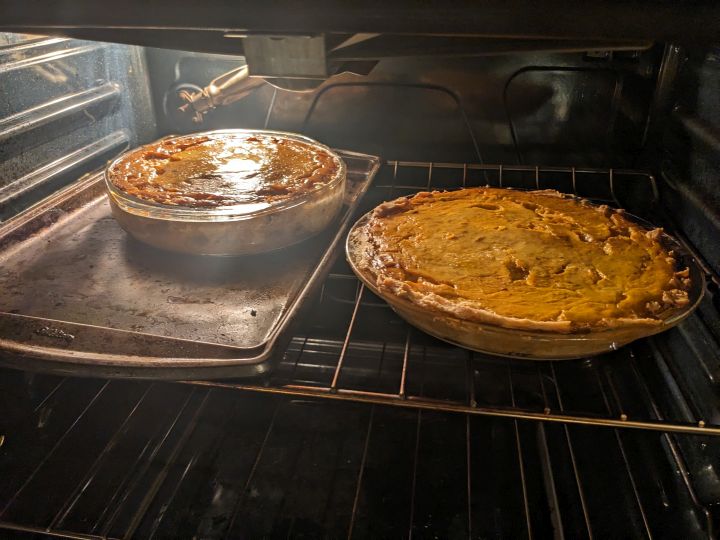 Two cushaw pumpkin pies cooling in the oven